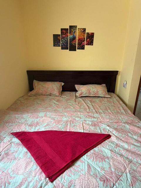 Bedroom with double bed and wall art