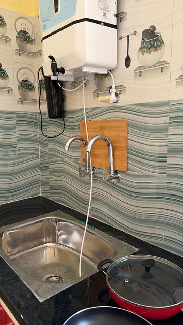Kitchen sink with wall-mounted water heater