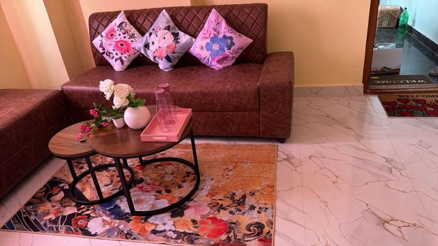 Gowlidoddi 1BHK living room with sofa and nesting coffee tables