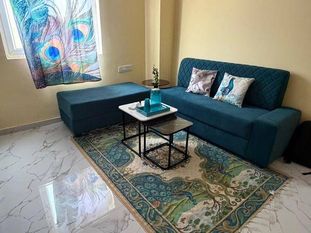 Teal sofa with coffee table by the window