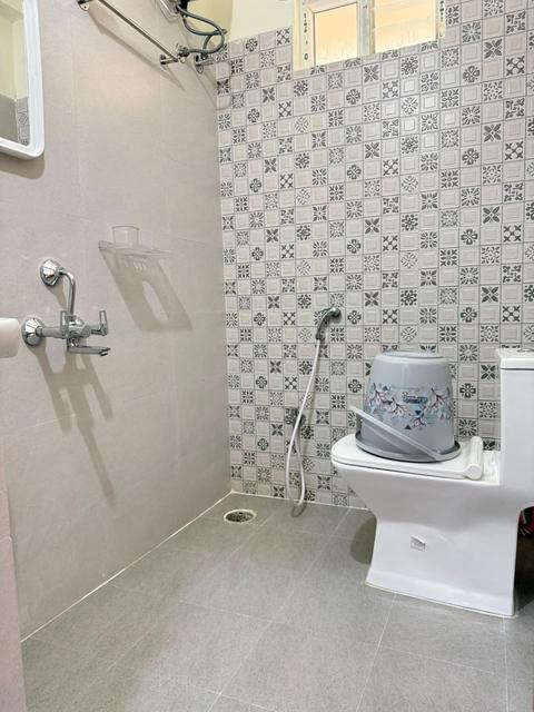 Bathroom with western toilet and patterned tiles