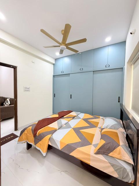 Bedroom with built-in blue wardrobe and double bed