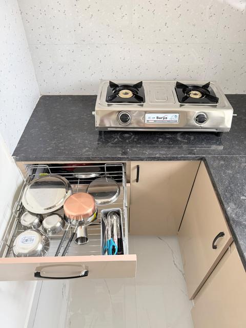 Kitchen with two-burner gas stove and utensil drawer