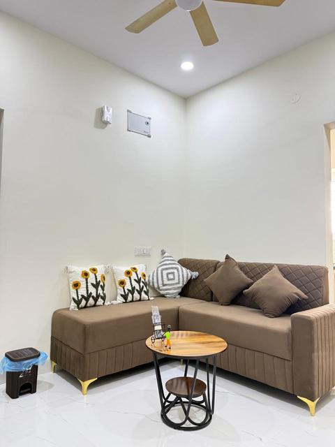 Living room with L-shaped sofa and round coffee table