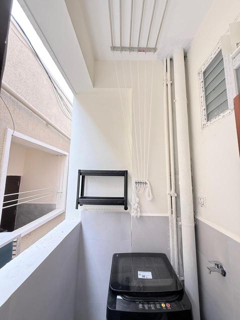Utility balcony with washing machine and ceiling cloth-drying rack