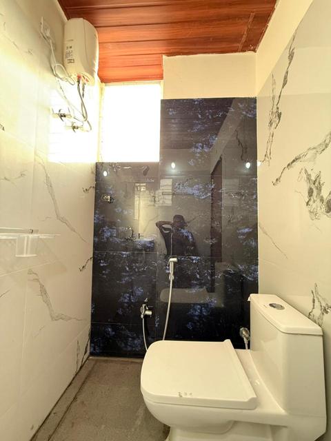 Bathroom with shower area, western toilet and water heater