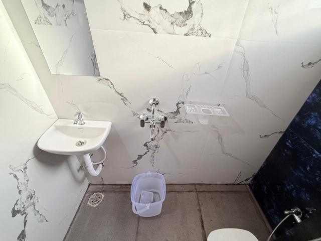 Bathroom with marble-finish tiles and washbasin