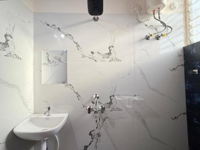 Bathroom with washbasin and wall-mounted water heater