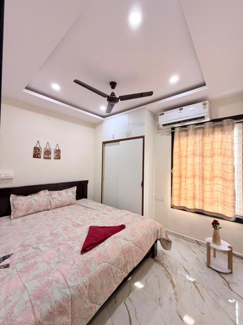 Bedroom with double bed, air conditioner and wardrobe
