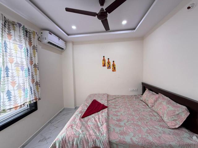 Bedroom with double bed and wall hangings