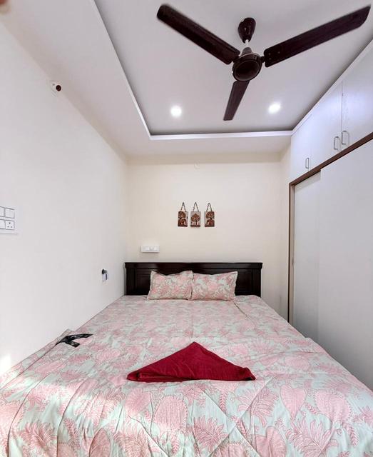 Penthouse bedroom with double bed, ceiling fan and wardrobe