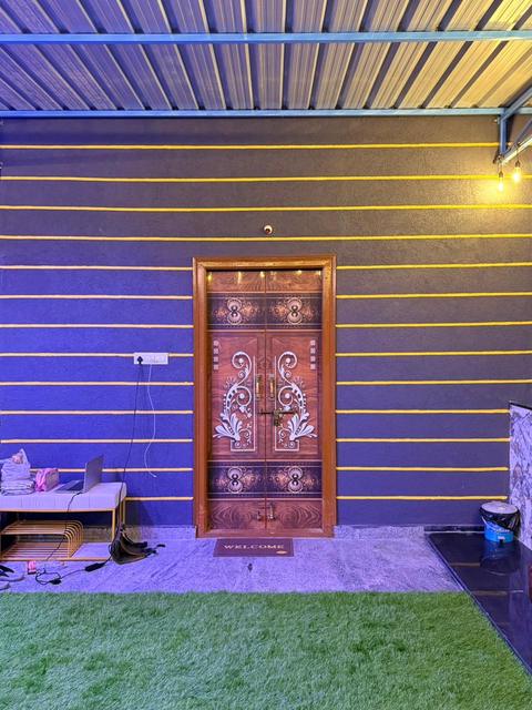 Carved wooden main door of the penthouse opening onto the terrace