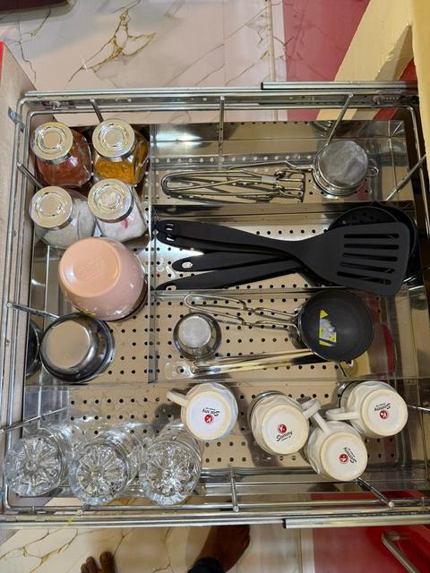 Kitchen drawer with crockery, cups and utensils