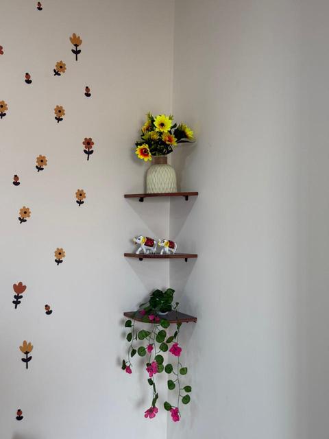 Floral wall decor with corner shelves and flowers